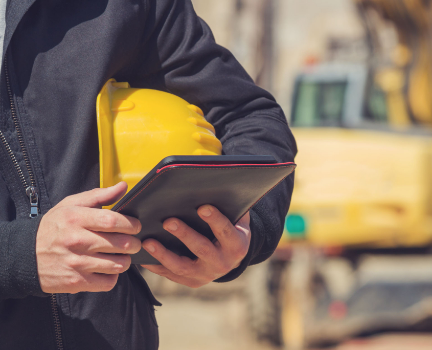 Close Up Construction Worker And Tablet